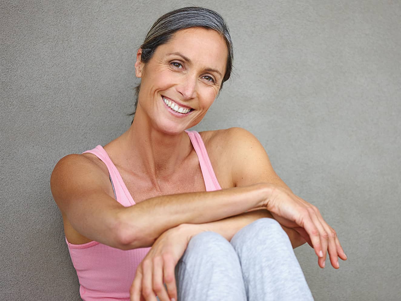 smiling athletic middle aged woman sitting down