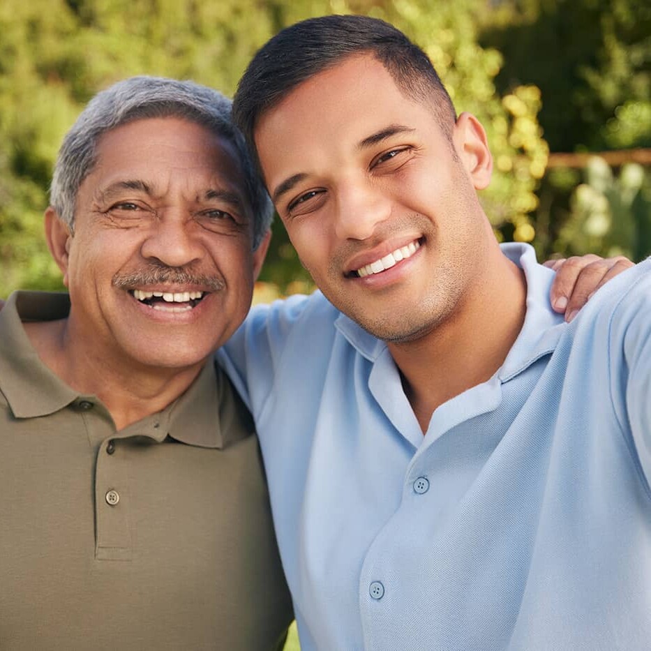 smiling older man with younger man taking selfie